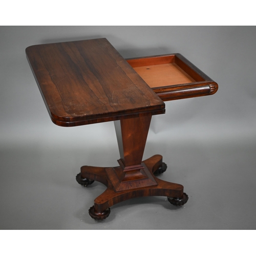 876 - A Victorian rosewood tea table, the fold over top raised on a square tapering support to a shaped qu... 