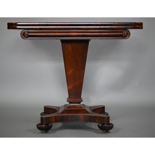 876 - A Victorian rosewood tea table, the fold over top raised on a square tapering support to a shaped qu... 