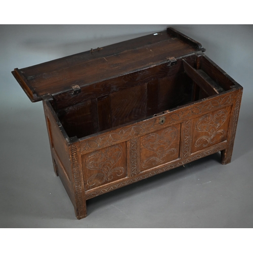 879 - A late 17th century joint oak coffer, the plank top over a triple heart design carved front, on stil... 