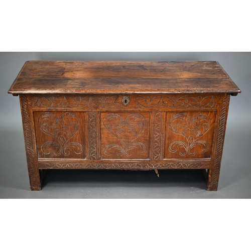 879 - A late 17th century joint oak coffer, the plank top over a triple heart design carved front, on stil... 