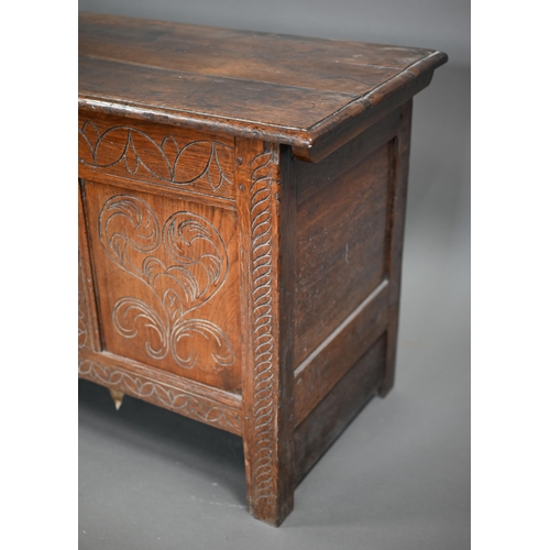 879 - A late 17th century joint oak coffer, the plank top over a triple heart design carved front, on stil... 