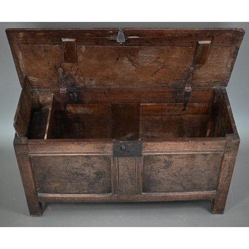 880 - A late 17th/18th century joint oak coffer, the two plank top a twin panelled front, on stiles, 104 c... 