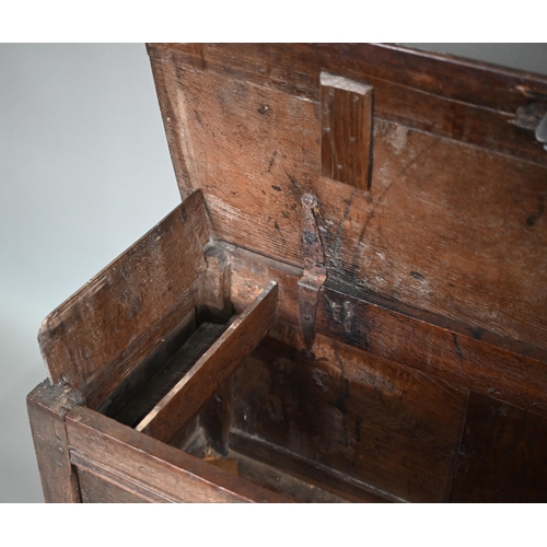 880 - A late 17th/18th century joint oak coffer, the two plank top a twin panelled front, on stiles, 104 c... 