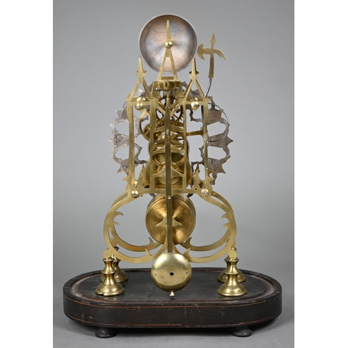 894 - A brass skeleton clock, the single fusee movement with silvered dial raised on an ebonised plinth un... 