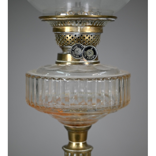 904 - An antique brass column and etched glass shade oil lamp, raised on a brown glazed pottery base, 67 c... 