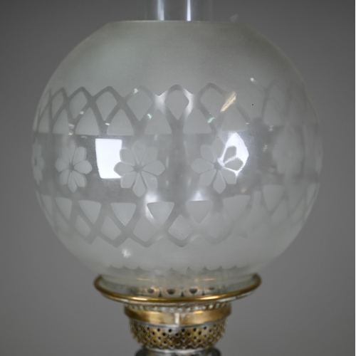 904 - An antique brass column and etched glass shade oil lamp, raised on a brown glazed pottery base, 67 c... 