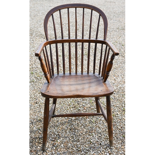 905 - An antique elm seat hoop and stick-back Windsor chair, raised on turned legs and stretchers