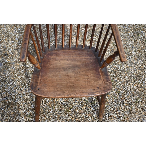 905 - An antique elm seat hoop and stick-back Windsor chair, raised on turned legs and stretchers