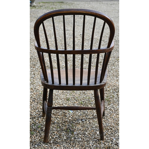 905 - An antique elm seat hoop and stick-back Windsor chair, raised on turned legs and stretchers