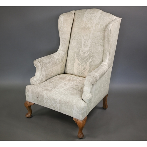 906 - A Georgian style wingback armchair in pale regency print fabric, raised on bleached cabriole front l... 