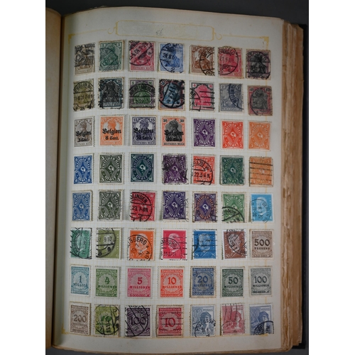 921 - Four albums of Victorian and later British Empire and foreign postage stamps, to/w a tin of loose st... 