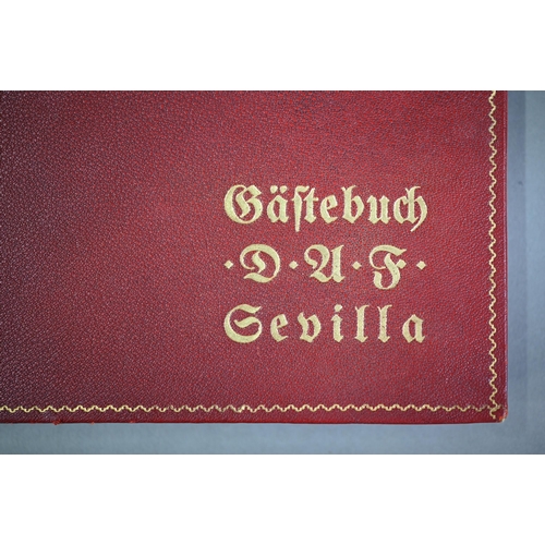 925 - A German gilt-tooled red Morocco leather visitors' book, Seville 1938 - 1943, signed and inscribed b... 