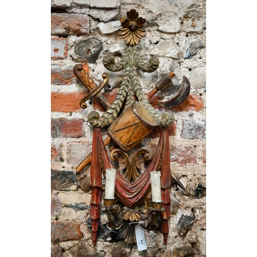 972 - A continental carved giltwood and polychrome twin branch wall sconce, with drum, sword an axe design... 