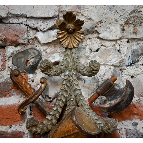 972 - A continental carved giltwood and polychrome twin branch wall sconce, with drum, sword an axe design... 