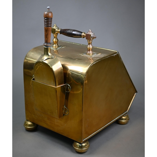 979 - An Arts & Crafts brass coal scuttle in the manner of Benson/Dresser, with turned wood handle and... 