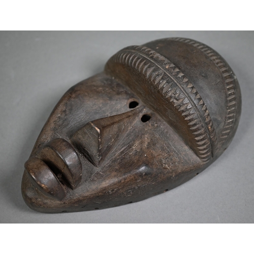 987 - A Bambara (Mali) carved wood mask with six-tooth 'comb' top supporting a male figure with pipe, 64 c... 