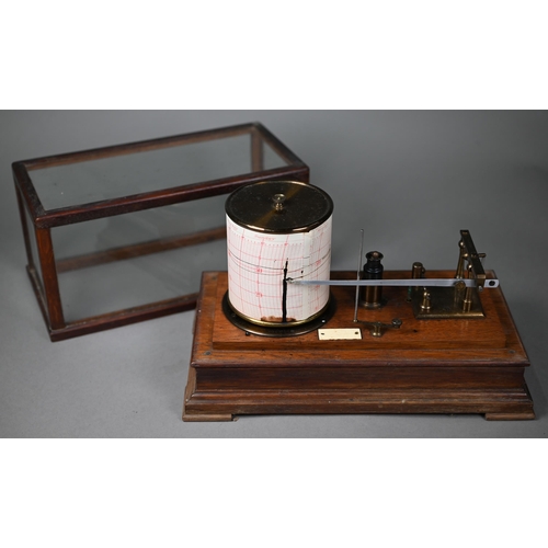 992 - A vintage barograph in glazed oak case, 32 cm wide, to/w two boxes of spare charts and a bottle of i... 