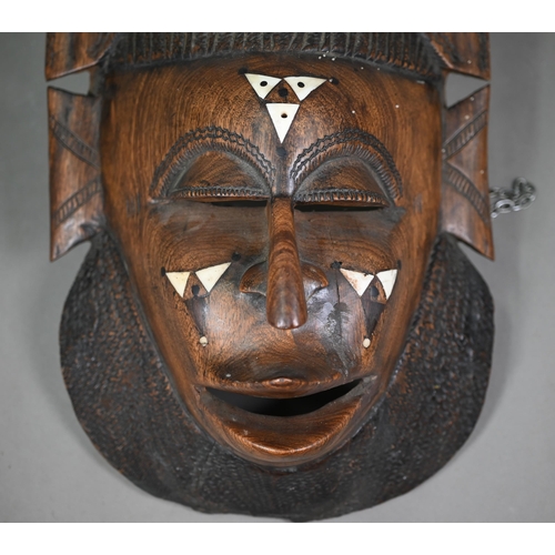 996 - An African tribal mask with bone inlays, surmounted by elephant head-piece, 56 cm high, to/w an Asha... 