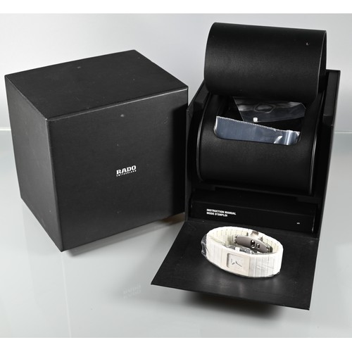 432 - Rado, a white cased lady's wristwatch, quartz movement, on deployment bracelet, with box, manual and... 