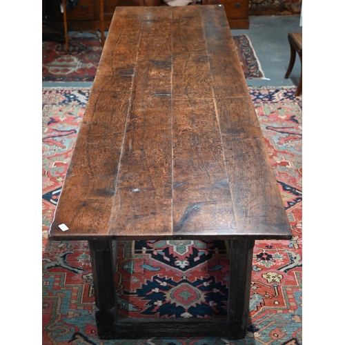 814 - A 17th century oak refectory table, the four plank top raised on a joined six moulded and chamfered ... 