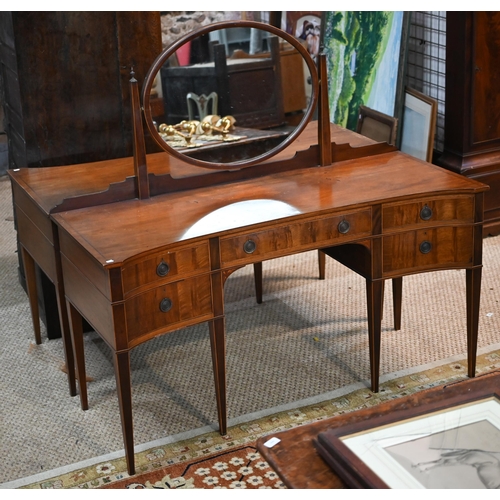 821 - A companion pair of mahogany dressing tables, of concave outline, one with a mirrored back over an a... 