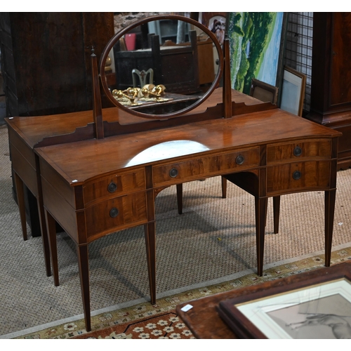 821 - A companion pair of mahogany dressing tables, of concave outline, one with a mirrored back over an a... 