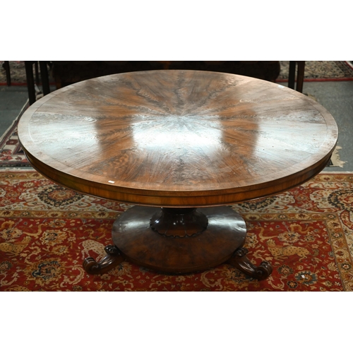828 - A Victorian style radially veneered flame mahogany breakfast table, the circular tilt top raised on ... 