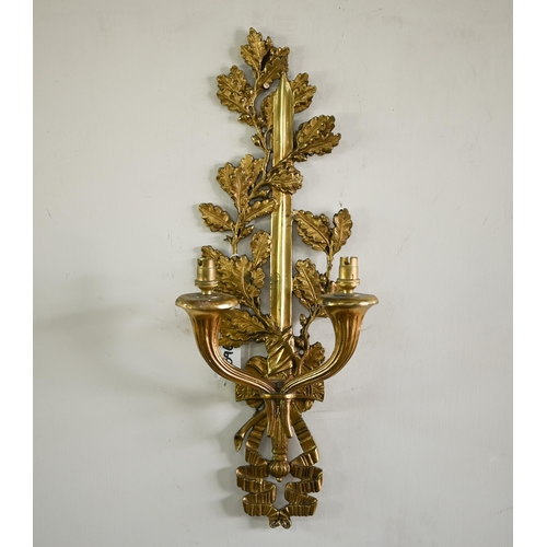 973 - A set of four ormolu twin branch wall  sconces/light fittings, with oakleaf, sword and ribbon bow de... 