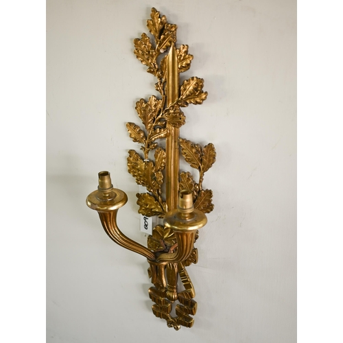 973 - A set of four ormolu twin branch wall  sconces/light fittings, with oakleaf, sword and ribbon bow de... 