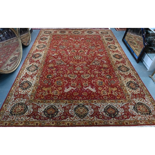 724 - A large Indo Persian Tabriz carpet, mid 20th century, the all-over floral and animal design on red-b... 