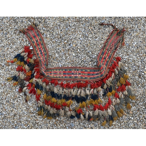 765 - A vintage Middle Eastern woven camel harness, with tassle end executed in multi-colours, 150 cm x 25... 