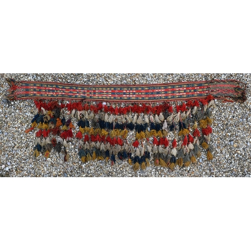 765 - A vintage Middle Eastern woven camel harness, with tassle end executed in multi-colours, 150 cm x 25... 