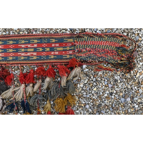 765 - A vintage Middle Eastern woven camel harness, with tassle end executed in multi-colours, 150 cm x 25... 