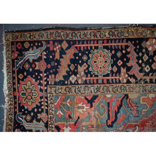 720 - An antique Persian Heriz carpet, the centre  medallion design on pale blue and camel ground, 340 cm ... 
