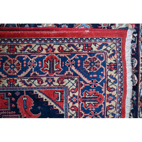 751 - A Persian Hamadan carpet, the red/blue ground centred by a medallion, 216 cm x 372 cm