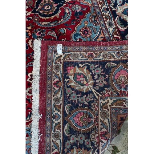 754 - A contemporary Persian Kashan carpet, the blue ground with mult-coloured geometric design, 384 cm x ... 