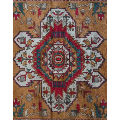 758 - A contemporary Shirvan rug, the triple medallion design on camel-gold ground, 240 cm x 130 cm