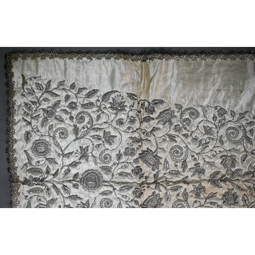 1021 - A Sicilian idol shawl, profusely embroidered with silver wire/metalised threads and sequins, 52 x 10... 