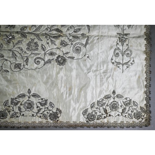 1021 - A Sicilian idol shawl, profusely embroidered with silver wire/metalised threads and sequins, 52 x 10... 