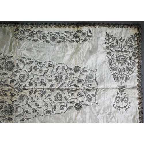 1021 - A Sicilian idol shawl, profusely embroidered with silver wire/metalised threads and sequins, 52 x 10... 