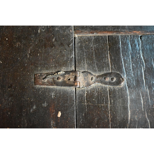 832 - A 17th century Welsh oak box settle, the crest rail with lunette carved decoration over further carv... 