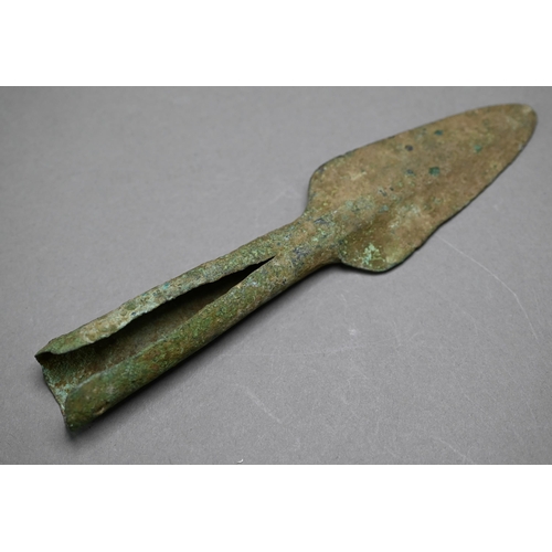 1004 - A Bronze Age sword, the tapering fullered blade with midrib, extending from oval shoulder, with colu... 