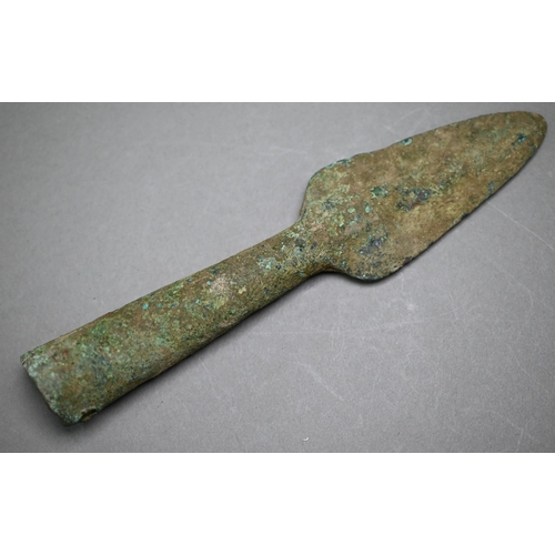 1004 - A Bronze Age sword, the tapering fullered blade with midrib, extending from oval shoulder, with colu... 