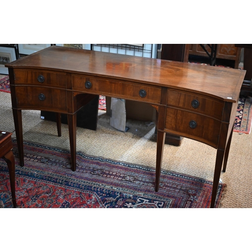 821 - A companion pair of mahogany dressing tables, of concave outline, one with a mirrored back over an a... 