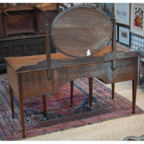 821 - A companion pair of mahogany dressing tables, of concave outline, one with a mirrored back over an a... 