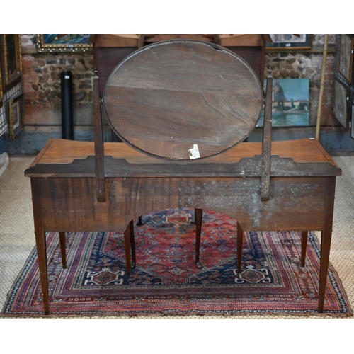 821 - A companion pair of mahogany dressing tables, of concave outline, one with a mirrored back over an a... 