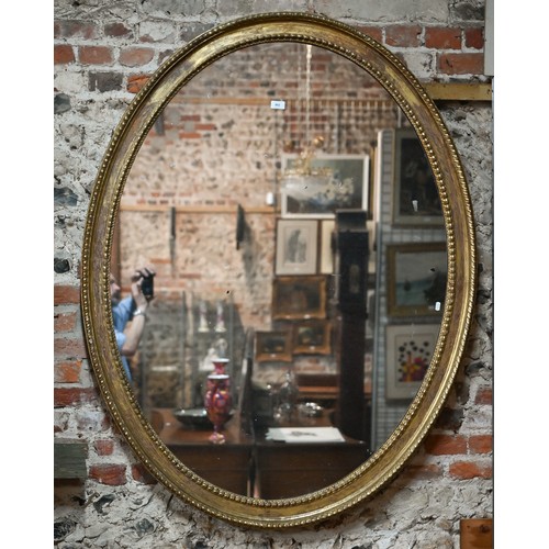 862 - A large Victorian oval giltwood framed mirror, 145 cm x 112 cm