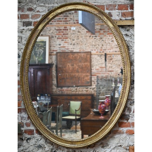 862 - A large Victorian oval giltwood framed mirror, 145 cm x 112 cm