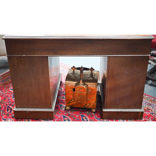 874 - A Victorian walnut twin pedestal desk, the inset tan leather top over an arrangement of moulded edge... 