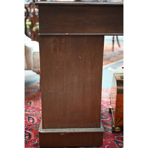 874 - A Victorian walnut twin pedestal desk, the inset tan leather top over an arrangement of moulded edge... 